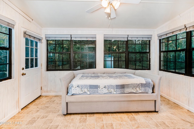 bedroom with wooden walls, baseboards, and ceiling fan