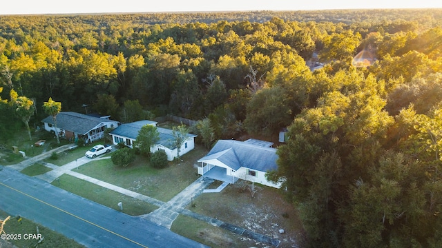 birds eye view of property with a view of trees