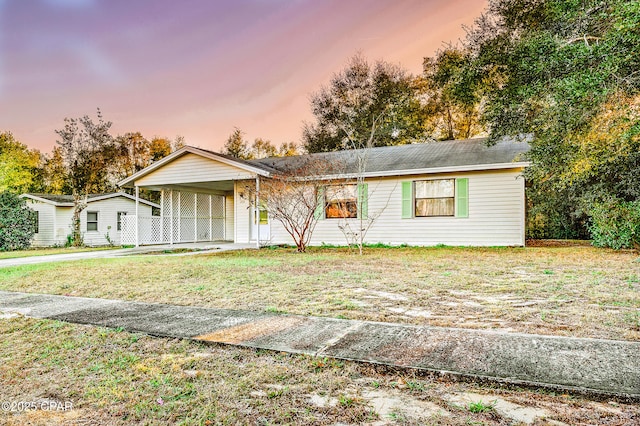 single story home with a lawn