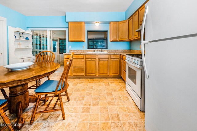 kitchen with sink and white appliances