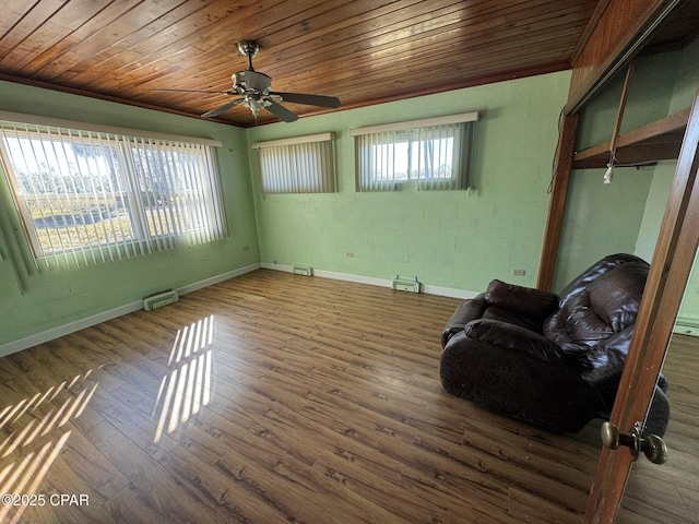 unfurnished room with lofted ceiling, wooden ceiling, dark wood-type flooring, ceiling fan, and a baseboard radiator