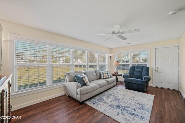 living room with ceiling fan and dark wood-type flooring