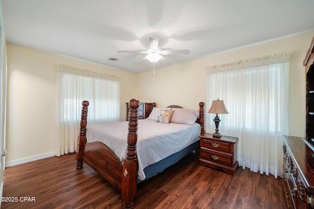 bedroom with multiple windows, ceiling fan, and dark hardwood / wood-style flooring