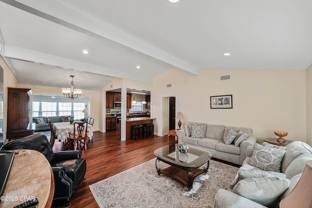 living room featuring a chandelier, lofted ceiling with beams, and dark hardwood / wood-style floors