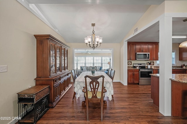 dining area with dark hardwood / wood-style floors, lofted ceiling, and a chandelier