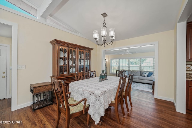 dining room with dark hardwood / wood-style floors, an inviting chandelier, and vaulted ceiling with beams