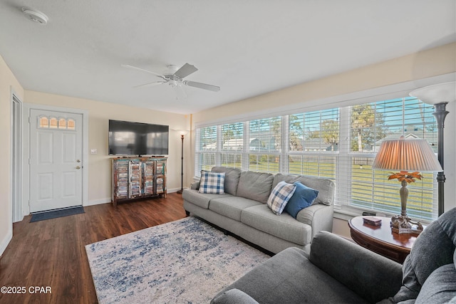 living room featuring ceiling fan and dark wood-type flooring