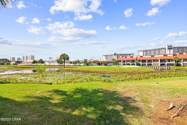 view of home's community featuring a water view and a yard