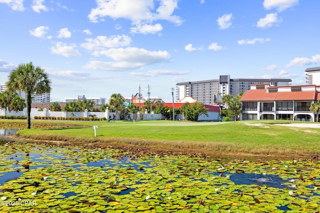 surrounding community featuring a yard and a water view