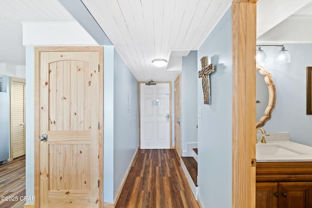 corridor with sink, wooden ceiling, and dark hardwood / wood-style floors