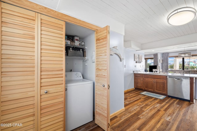 washroom with sink, washer / clothes dryer, dark wood-type flooring, and wood ceiling