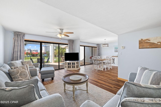 living room with wood-type flooring and ceiling fan