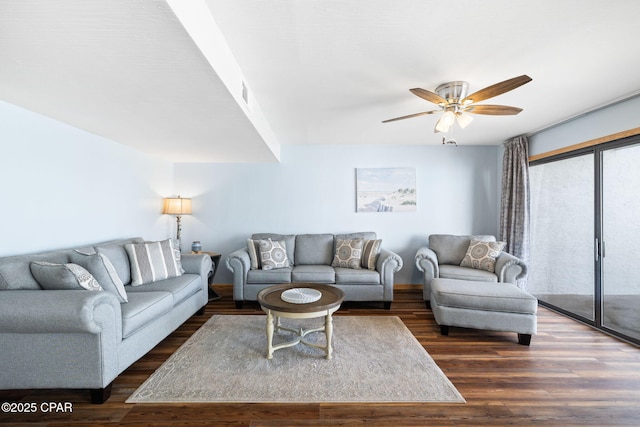 living room featuring dark hardwood / wood-style floors and ceiling fan