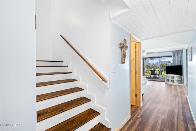 staircase featuring wood ceiling and hardwood / wood-style flooring