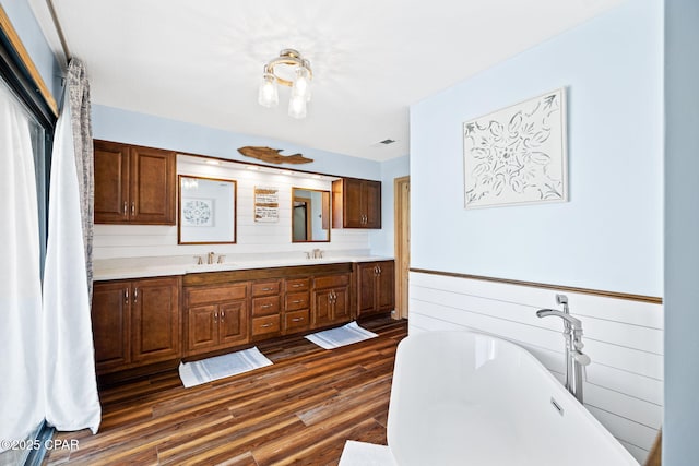 bathroom featuring a tub, wood-type flooring, and vanity