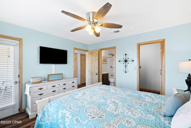 bedroom featuring ceiling fan, ensuite bathroom, and dark hardwood / wood-style flooring