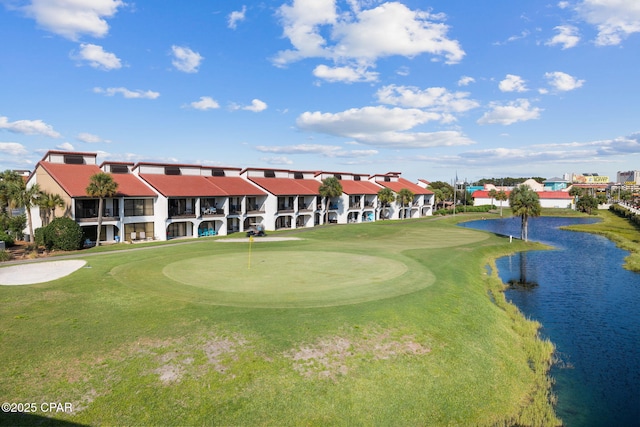 surrounding community featuring a water view and a lawn