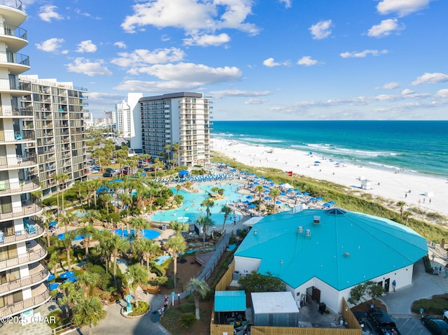 birds eye view of property featuring a beach view and a water view