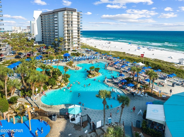 birds eye view of property with a water view and a beach view