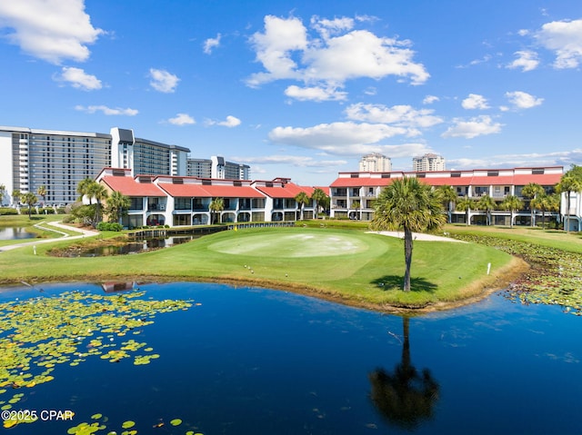 view of property's community featuring a water view and a yard