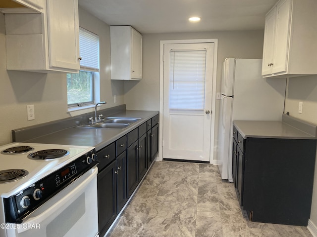 kitchen featuring white range with electric cooktop, white cabinetry, and sink