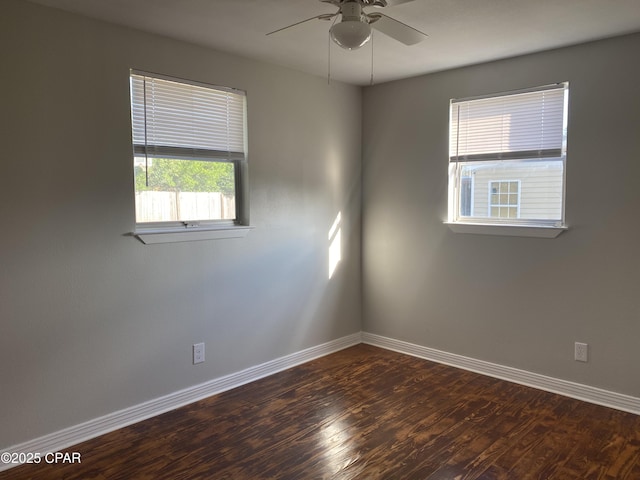 empty room featuring ceiling fan and dark hardwood / wood-style flooring