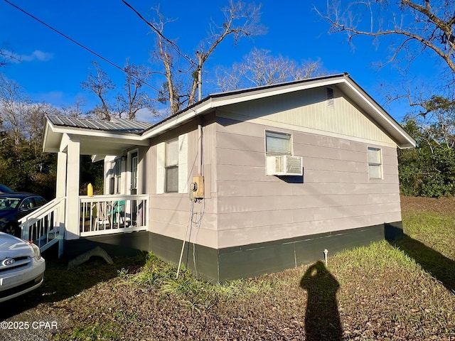 view of side of property with covered porch