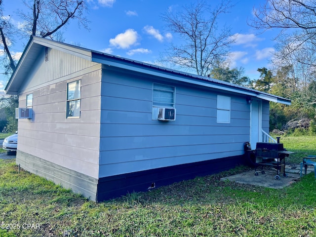 view of side of property with a patio area and cooling unit