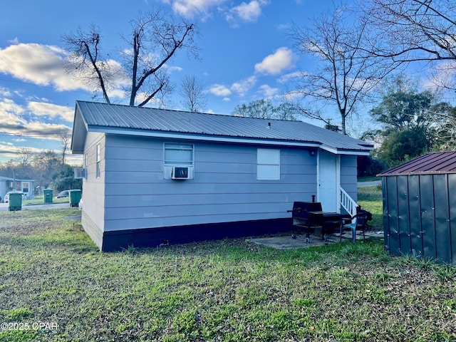 back of house with an outbuilding and a yard