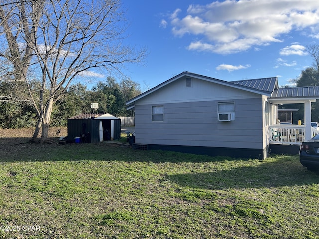 view of side of property with a shed and a lawn