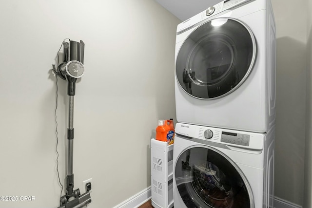 washroom featuring stacked washer and dryer