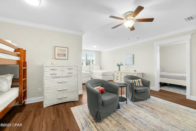 bedroom with dark hardwood / wood-style floors, ceiling fan, and crown molding