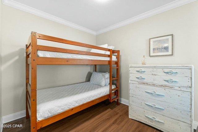 bedroom featuring crown molding and dark hardwood / wood-style floors