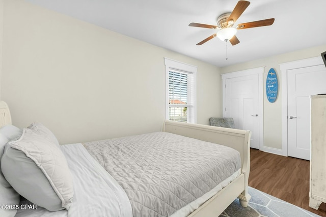 bedroom with ceiling fan and dark wood-type flooring