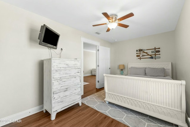 bedroom with hardwood / wood-style floors and ceiling fan