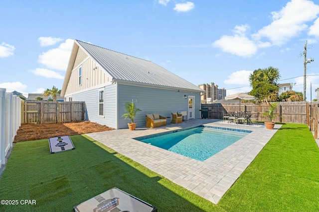 view of pool featuring a lawn and a patio area