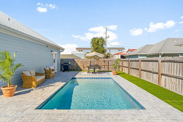 view of pool featuring a patio and grilling area