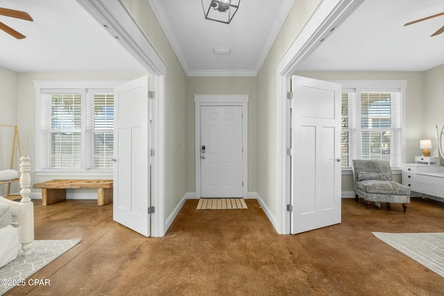 carpeted entryway with ceiling fan and crown molding