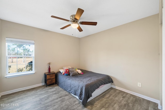 bedroom with ceiling fan and wood-type flooring