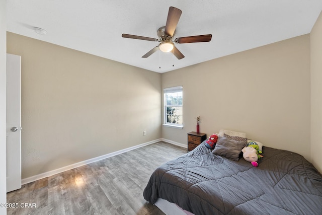 bedroom featuring ceiling fan and hardwood / wood-style floors