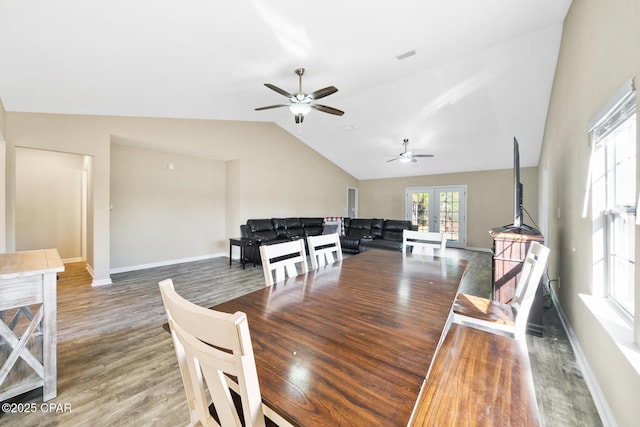 dining space with french doors, wood-type flooring, and lofted ceiling