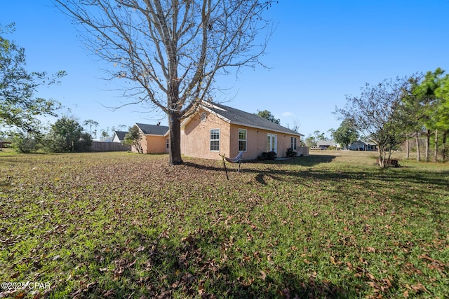 view of side of property featuring a yard