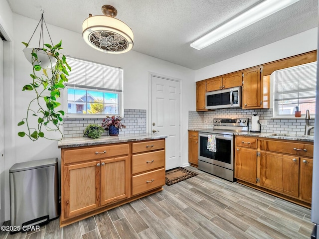 kitchen with sink, stainless steel appliances, and backsplash