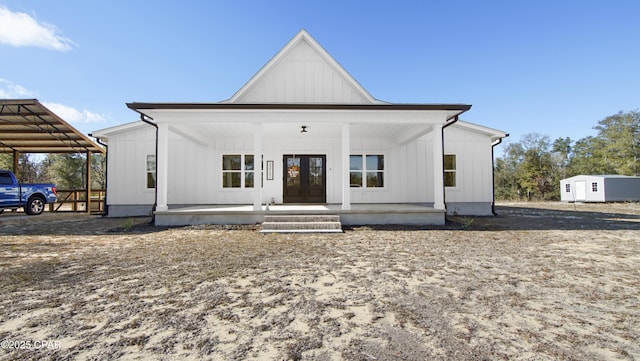 modern farmhouse style home with covered porch and french doors