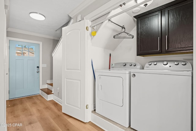 clothes washing area with cabinets, light wood-type flooring, separate washer and dryer, and crown molding