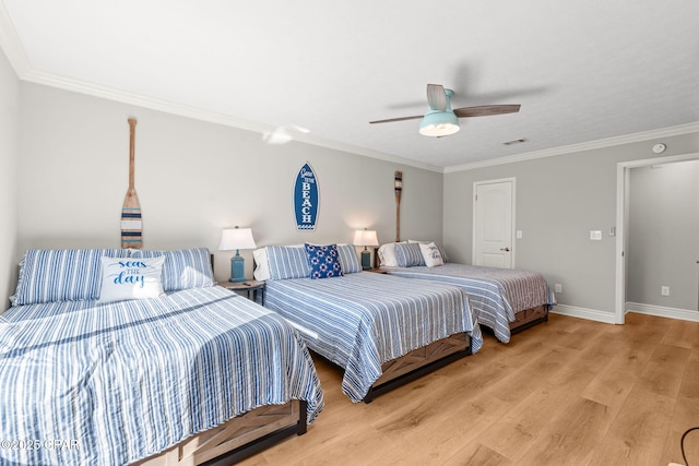 bedroom featuring ceiling fan, light hardwood / wood-style floors, and ornamental molding