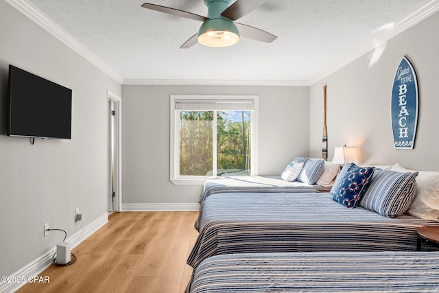 bedroom with ceiling fan, crown molding, and light hardwood / wood-style flooring