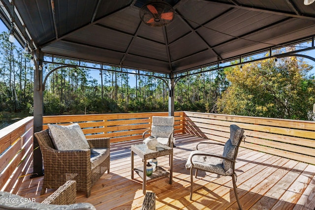 wooden deck featuring a gazebo and ceiling fan