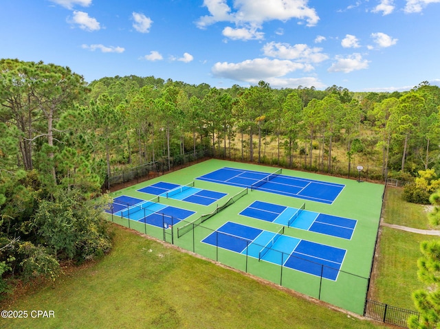 view of sport court featuring a lawn