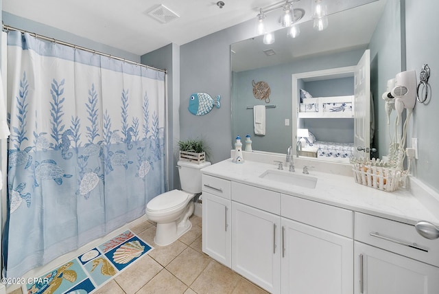 bathroom featuring tile patterned flooring, vanity, and toilet